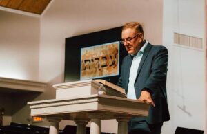 Congregation rejoicing and worshiping through hymns, choir anthems, and solos at Kennesaw First Baptist Church Classic Service.